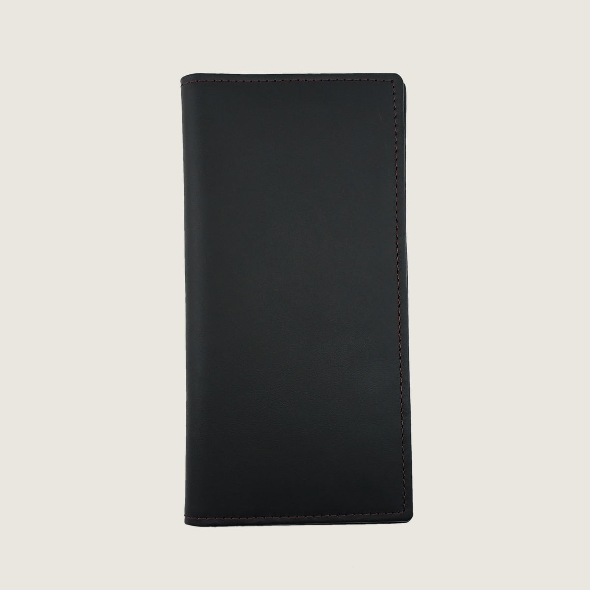 A minimalist black leather passport cover  with clean stitching, shown flat against a light beige background.