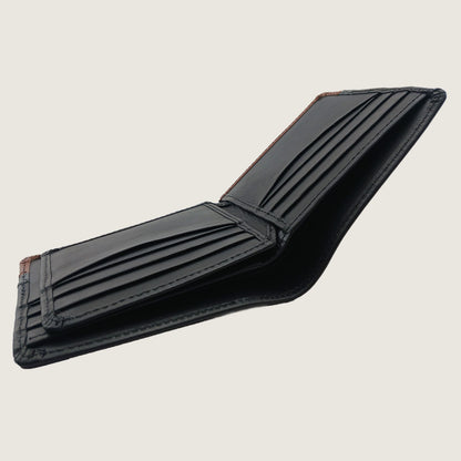 An open black leather bifold wallet with multiple card slots and bill compartments, shown on a light beige background.
