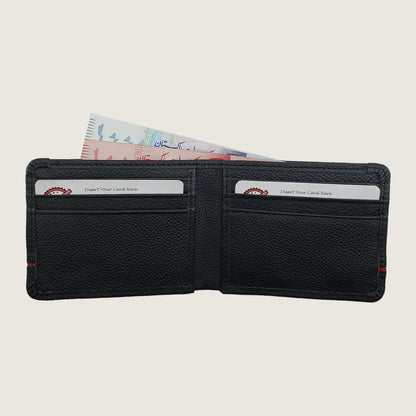 A black textured leather bi-fold wallet shown open, with two card slots containing sample credit cards and a banknote tucked inside, on a light beige background.