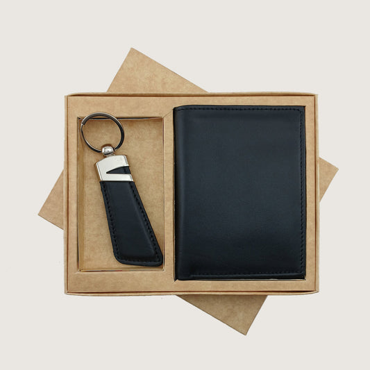 A black leather keychain and wallet gift set presented in a brown kraft paper box on a light beige background.