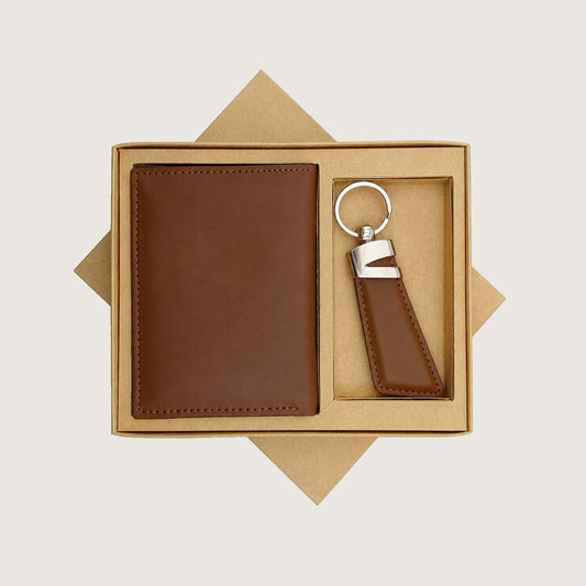 A brown leather wallet and matching keychain presented in a kraft gift box on a light beige background.