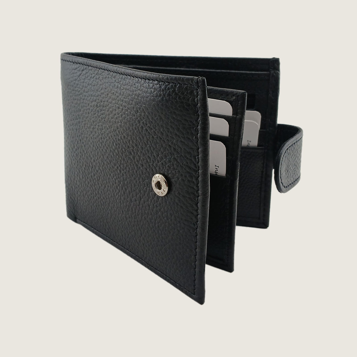 A black textured leather bifold wallet shown open, displaying its interior card slots and a silver snap button closure, set against a solid light beige background.
