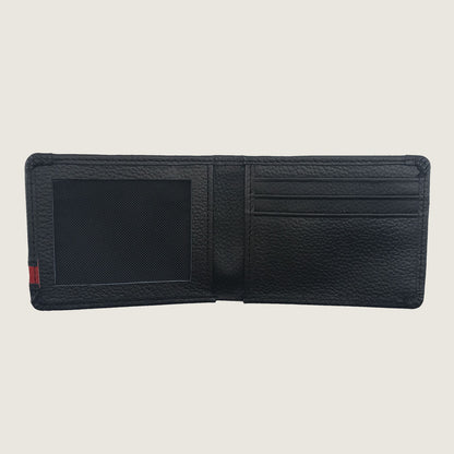 A black textured leather bifold wallet shown open, displaying its interior compartments including an ID window, card slots, and a small red and green stripe detail on the left edge, set against a solid light beige background.