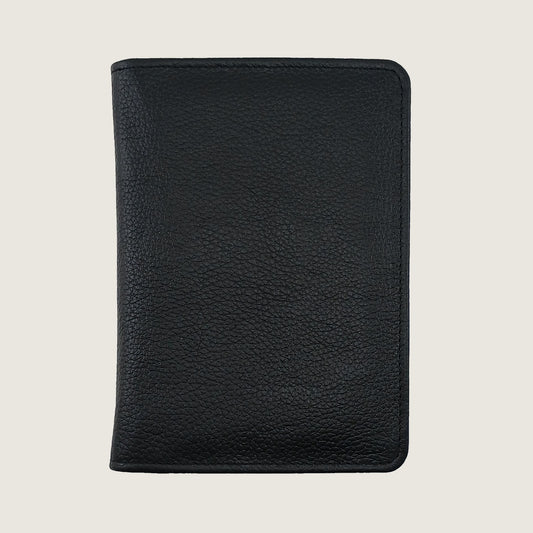 A black pebbled leather passport cover or document holder, shown closed from the front against a light beige background.