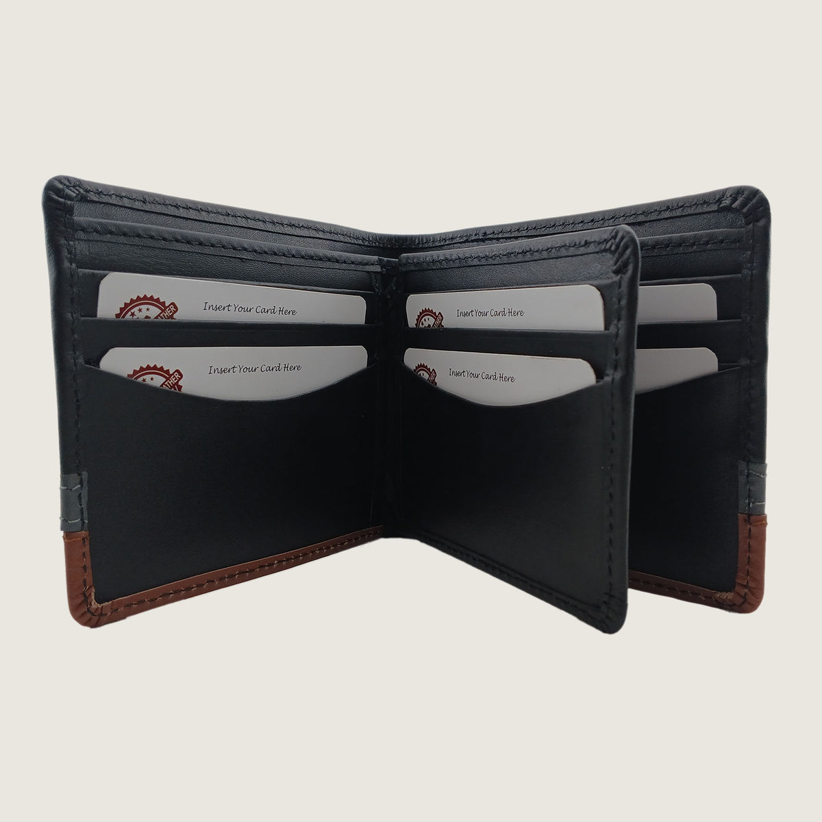 An open bi-fold wallet made of black leather with brown contrast stitching and trim, showing multiple card slots and card pockets, photographed against a light beige background.