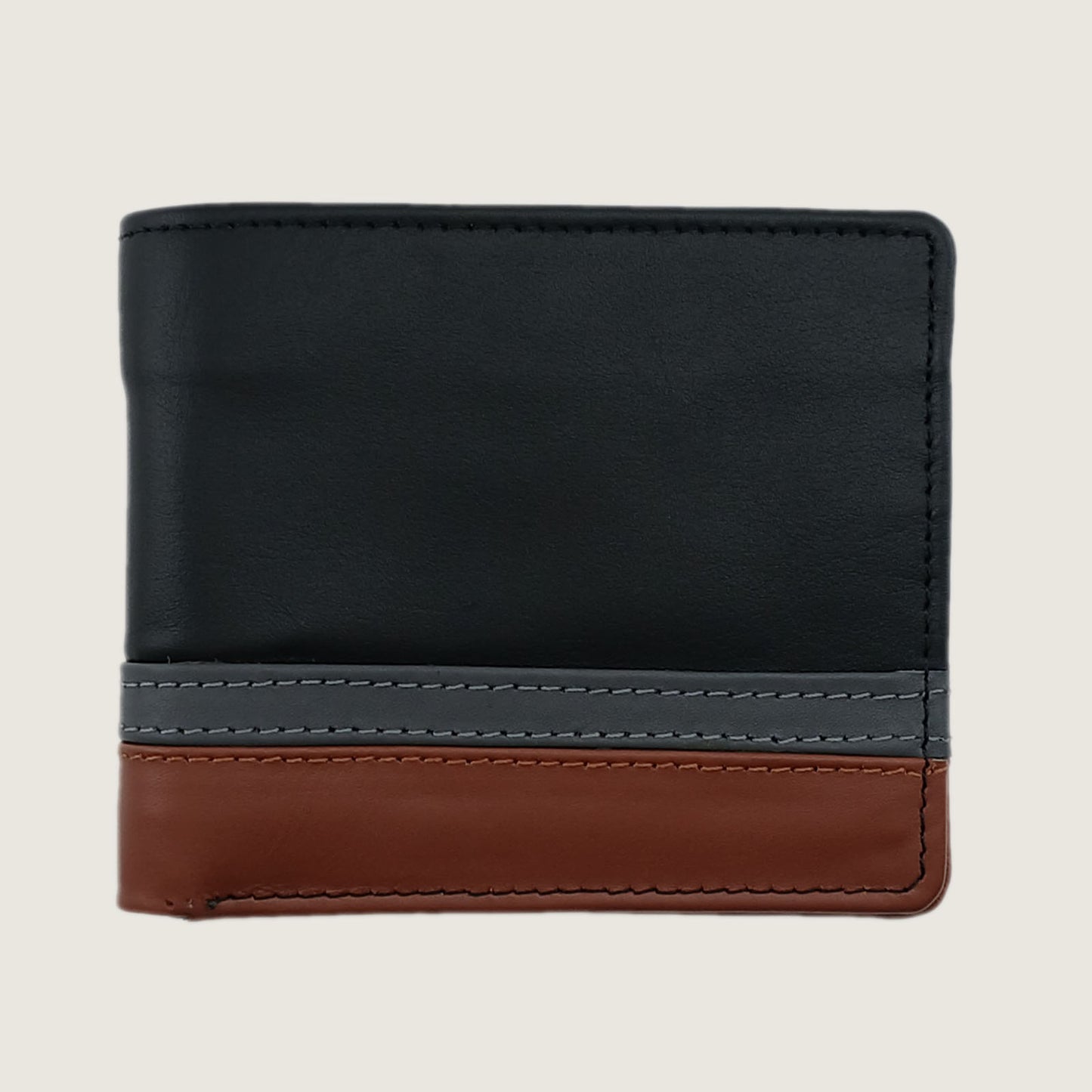 A color-blocked bifold wallet made of leather, featuring a large black upper section, a gray middle stripe with white stitching, and a brown lower section, shown on a light beige background.