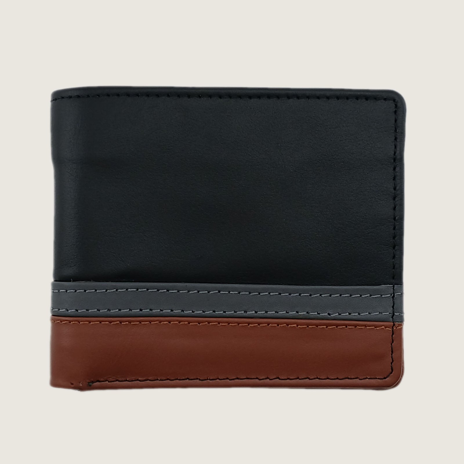 A color-blocked bifold wallet made of leather, featuring a large black upper section, a gray middle stripe with white stitching, and a brown lower section, shown on a light beige background.