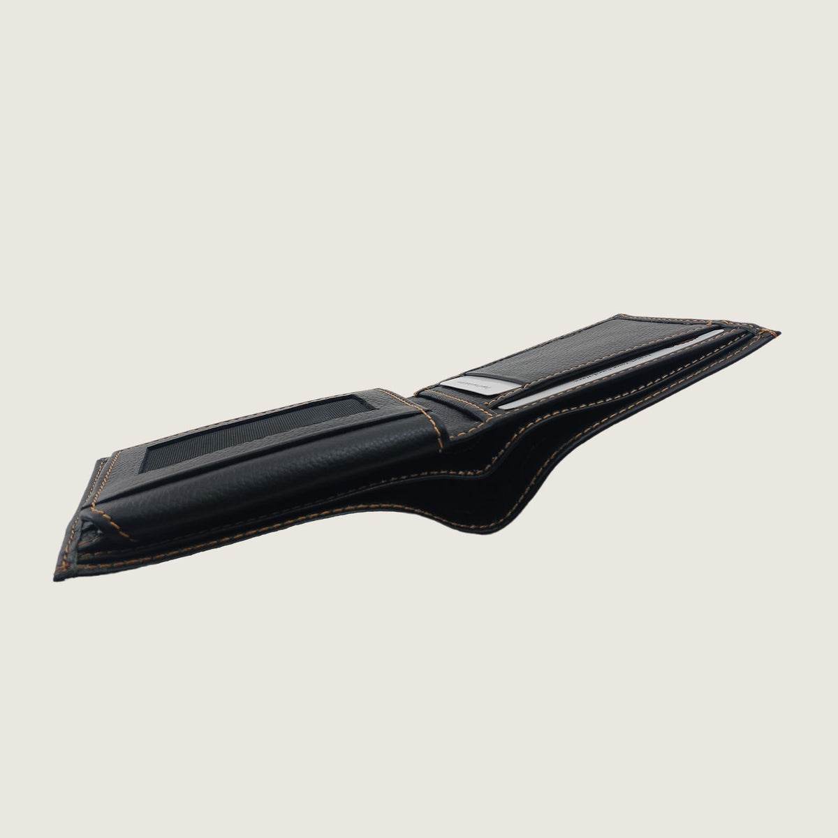 A black leather card holder wallet with gold contrast stitching, shown open against a solid light beige background.